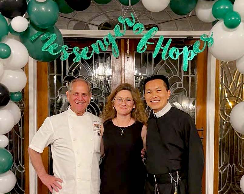Chef John Folse, Michaela York and Fr. Tat Hoang welcome guests to the Messengers of Hope Gala to raise funds for Redemptorist St. Gerard School in Baton Rouge.
