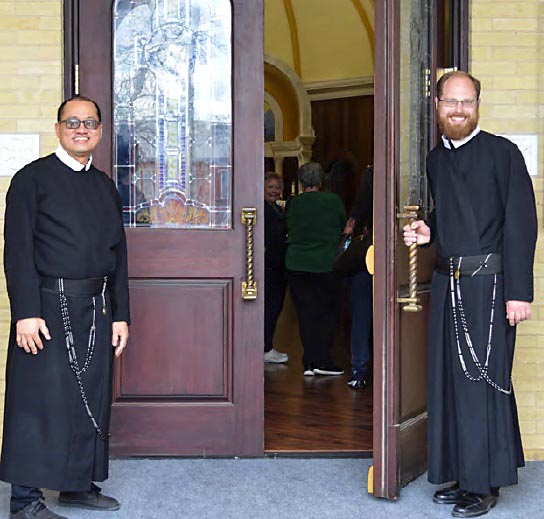 Thanh Vu and Steven Urban welcome one and all to the student mission; and all of the Redemptorist theology students process into St. Gerard Church.