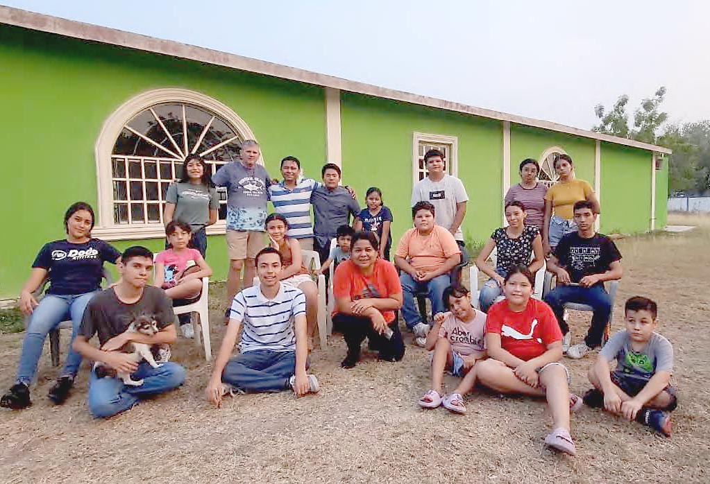 Fr. Patrick Keyes with children and young adults who enjoyed the mission.